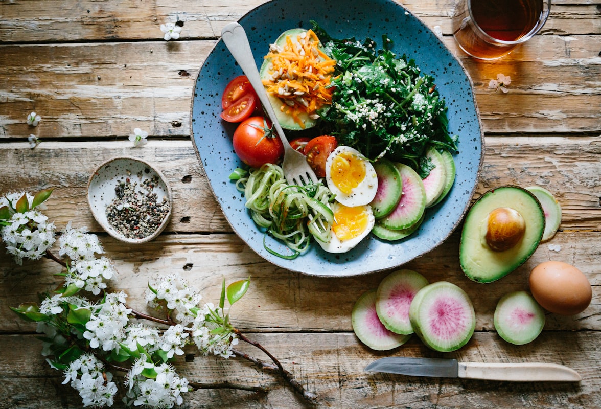 Healthy fat sources including avocados, nuts, seeds, and olive oil